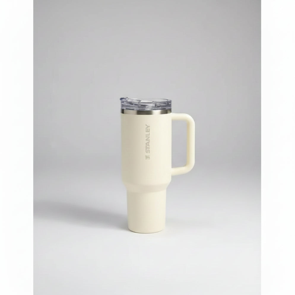 White mug with handle in front of Starbuck coffee boxes on a gray surface.