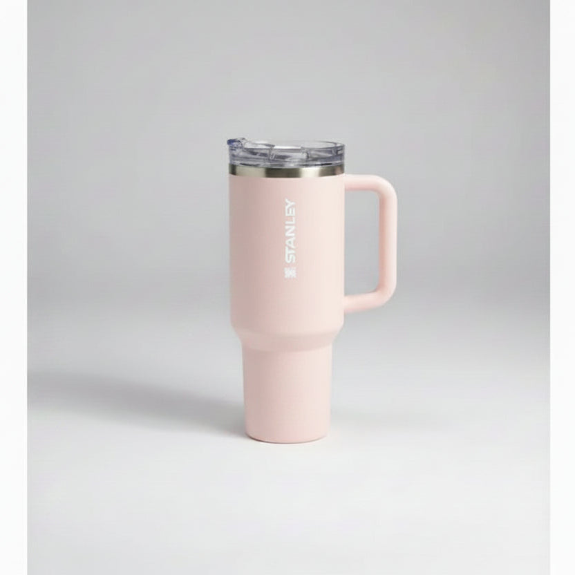 pink-colored travel mug with handle on a gray background