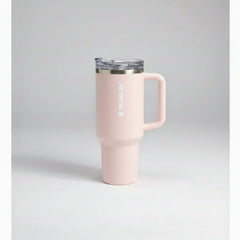 pink-colored travel mug with handle on a gray background