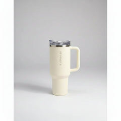 White mug with handle in front of Starbuck coffee boxes on a gray surface.