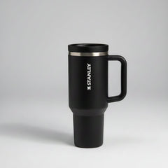 black-colored travel mug with handle on a gray background