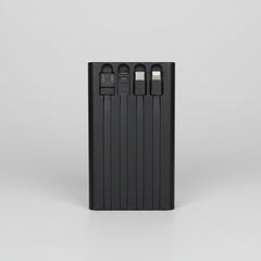 Black multi-port USB charger held in a hand with a blurred background