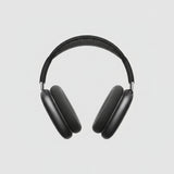 Black headphones on a white box with a light wooden surface background