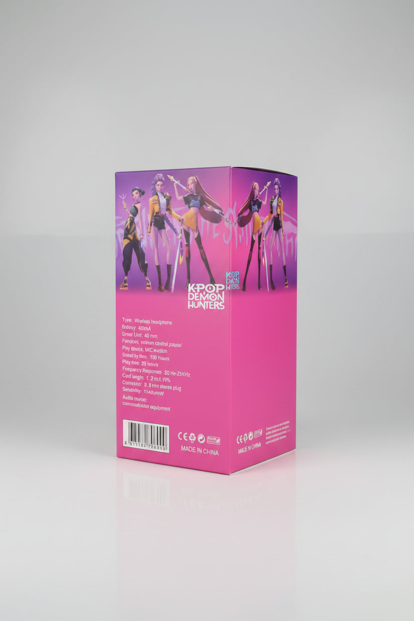 A hand holds a pink retail box for a K-pop themed wireless headset. The back of the box features illustrations of three female anime-style characters with swords and displays product specifications in white text.